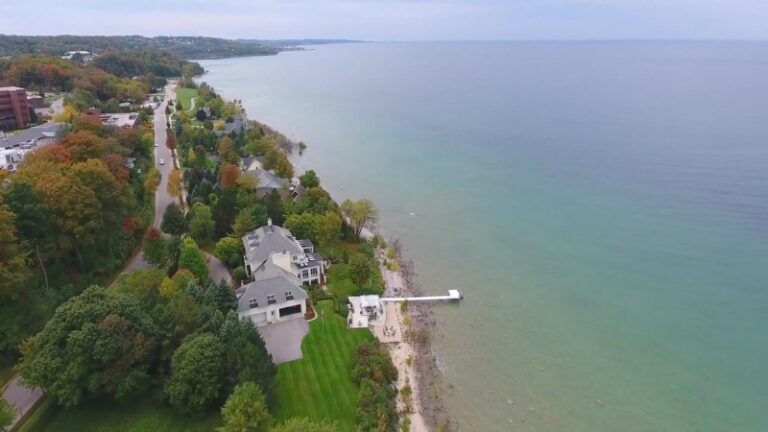 A serene shoreline along Lake Michigan, highlighting Lake Michigan vs. Lake Huron